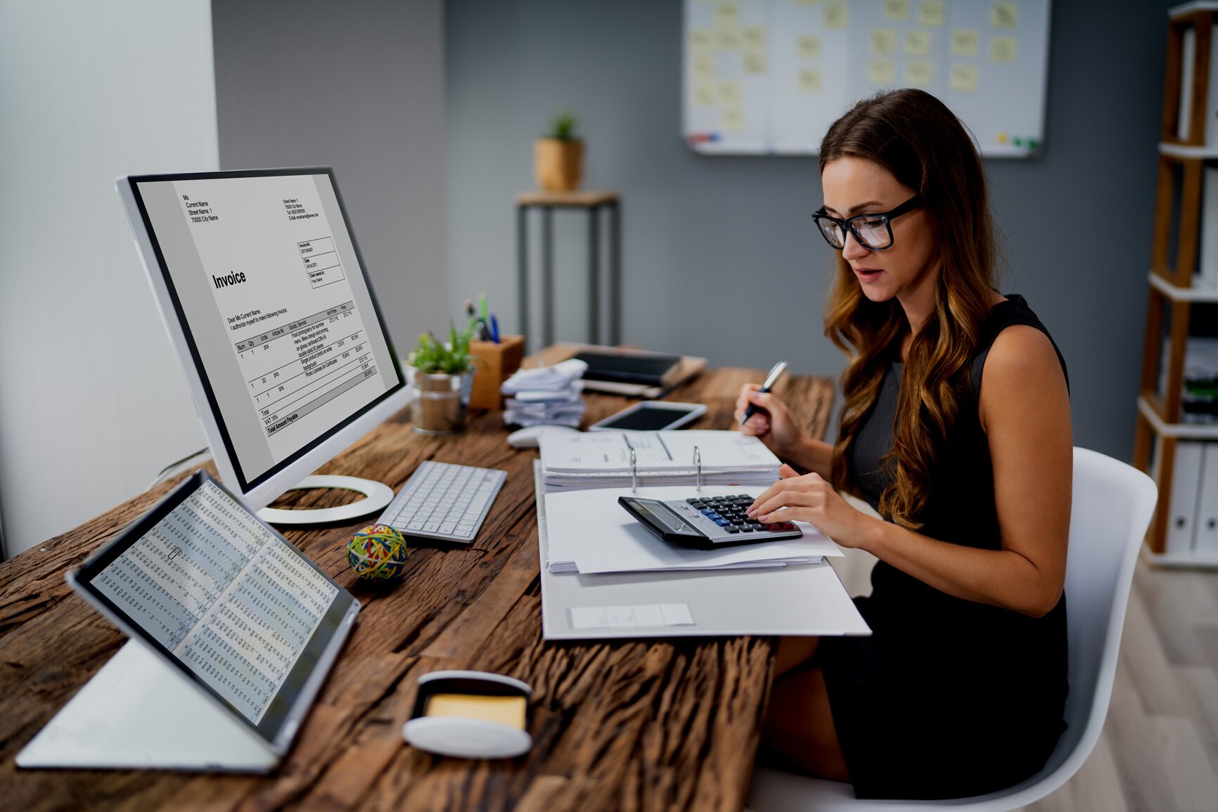 Accountant Calculating Tax At Desk